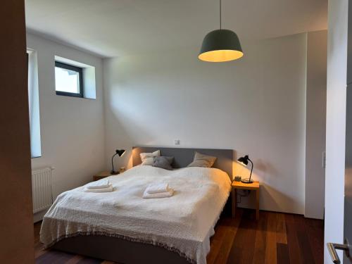 a bedroom with a bed with two towels on it at Ferienwohnung Faulhauer in Welschbillig