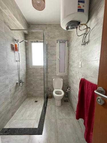 a bathroom with a shower and a toilet at Boho Breez Mountain View Chalet in Ras Elhekma