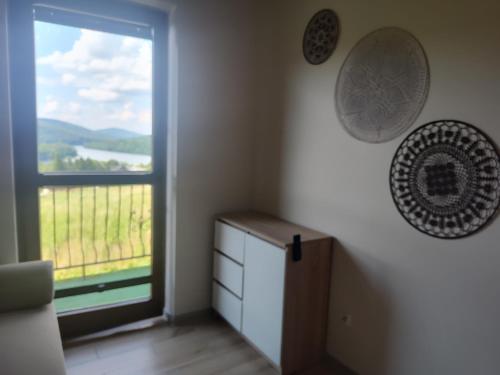 a room with a window and a dresser with a view at Noclegi nad Soliną in Solina