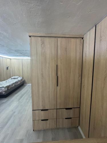 a bedroom with wooden cabinets and a bed at Sóstó Suites in Nyíregyháza