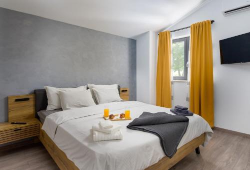 a bedroom with a large bed with orange curtains at Villa Nik by Istrialux in Svetvinčenat