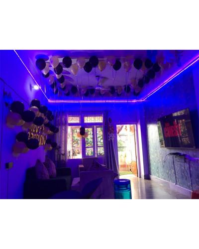a room with purple lighting and balloons hanging from the ceiling at The Hidden Gem Guwahati in Guwahati