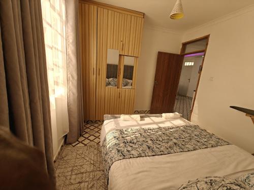 a hotel room with two beds and a window at Haven Homes in Nanyuki