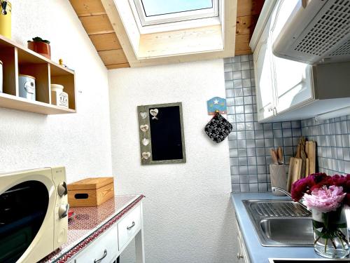a kitchen with a sink and a microwave at Landhaus Berthold in Bürserberg