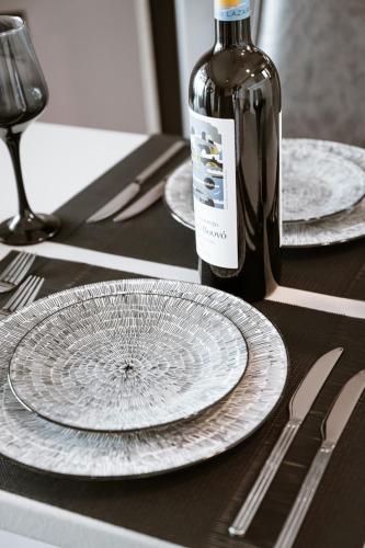 a table with two empty plates and a bottle of wine at Zante Sun Resort in Lithakia