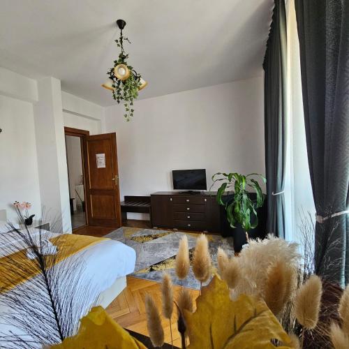 a bedroom with a bed and a chandelier at Apartment Zarnesti City Centre VMP Free Parking in Zărneşti