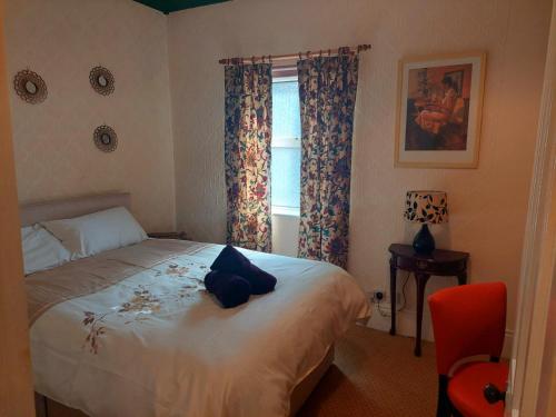 a bedroom with a bed and a window at Black Toms Tavern in Tinahely