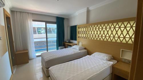 Postel nebo postele na pokoji v ubytování Aurasia Design Hotel