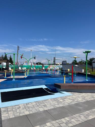 a water park with a playground with a water slide at Sara Apartament in Turek