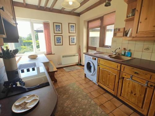 a kitchen with a washing machine and a sink at 3 Bed in Goathland oc-c32364 in Goathland