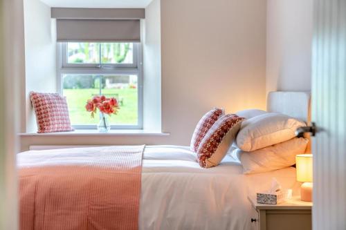 a bedroom with a bed with pillows and a window at 3 Bed in Reeth oc-l32438 in Reeth