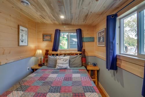a bedroom with a bed in a tiny house at Pequot Lakes Cabin with Dock on Loon Lake! in Pequot Lakes