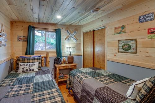 a bedroom with two beds in a log cabin at Pequot Lakes Cabin with Dock on Loon Lake! in Pequot Lakes