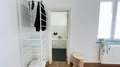 a white refrigerator with its door open in a room at 201 Loft Lumineux en Hyper-Centre in Liège