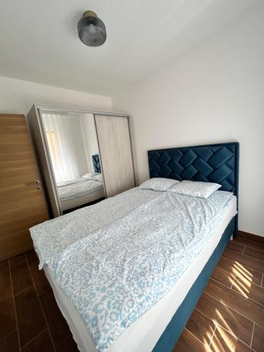 a bedroom with a bed with a mirror in it at ApartmanVID in Vrnjačka Banja