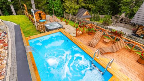 an overhead view of a swimming pool on a wooden deck at Aparthotel Delta Royal in Kościelisko