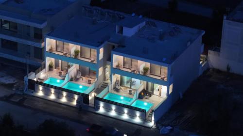 an aerial view of a building at night with lights at Elysian Luxury Suite in Preveza