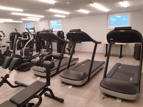 a gym with a bunch of exercise equipment in a room at Thermenhotel Kurz in Lutzmannsburg