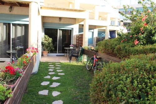 a garden with a bike parked next to a building at Nomi Suites Marina Herzelia in Herzelia 