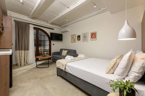 a bedroom with a bed and a couch in a room at Sea View Center 2 in Limenas