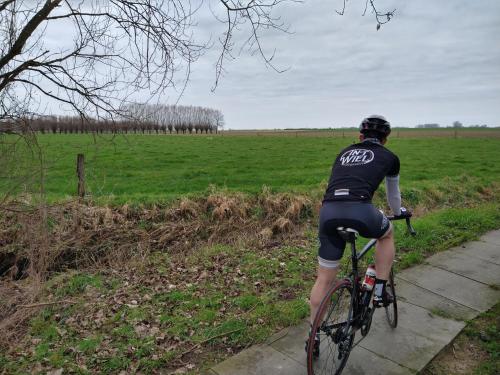 a person riding a bike down a sidewalk at In 't Wiel Oudenaarde in Oudenaarde