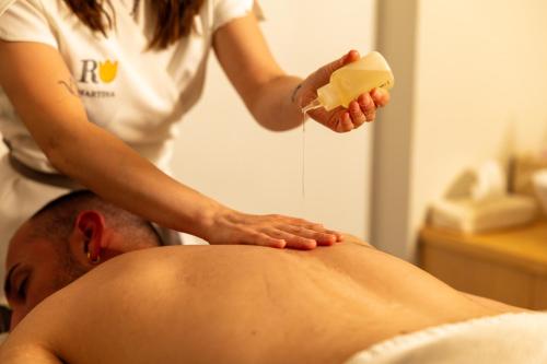 a woman is giving a man a massage at Roccafiore Wine Resort & Spa in Todi