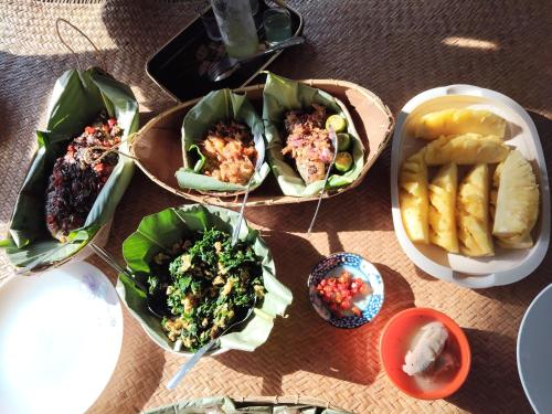 a group of plates of food on a table at Karen Tibura Homestay in Siburan