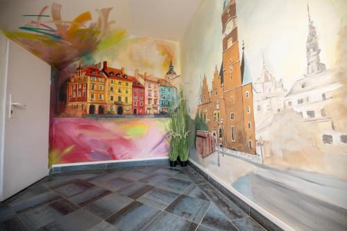 a room with a painting on the wall at City Place Noclegi in Wrocław