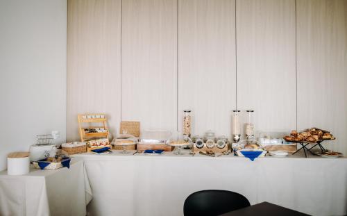 a white counter with a bunch of items on it at Hotel Eldorado in Apiro