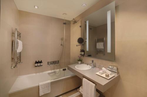 a bathroom with a sink and a mirror at NH Collection Milano President in Milan