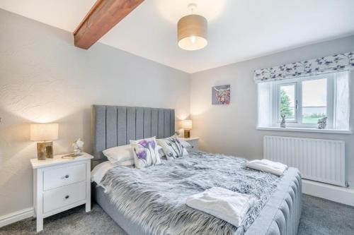 a bedroom with a large bed and a window at 2 Bed in Troutbeck oc-b32579 in Troutbeck