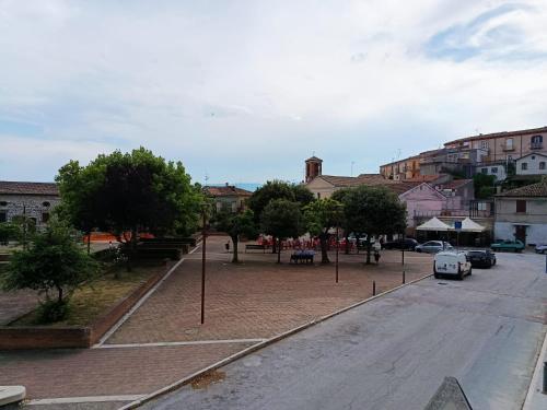 a street with cars parked on the side of the road at PIAZZA SANTANGELO - Home - in Busso