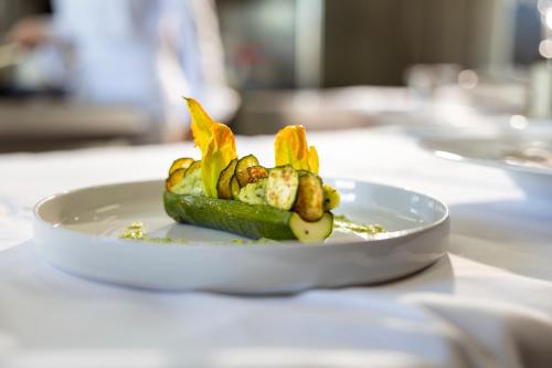 a plate of vegetables on a white plate on a table at Roccafiore Wine Resort & Spa in Todi