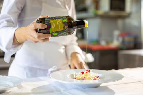 a woman taking a picture of a plate of food at Roccafiore Wine Resort & Spa in Todi