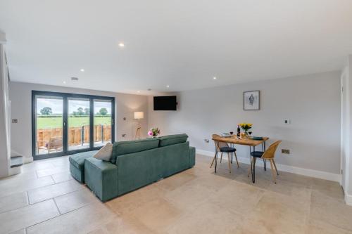 a living room with a green couch and a table at 1 Bed in Marishes oc-l32536 in Kirby Misperton