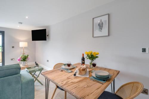 a dining room and living room with a wooden table at 1 Bed in Marishes oc-l32536 in Kirby Misperton