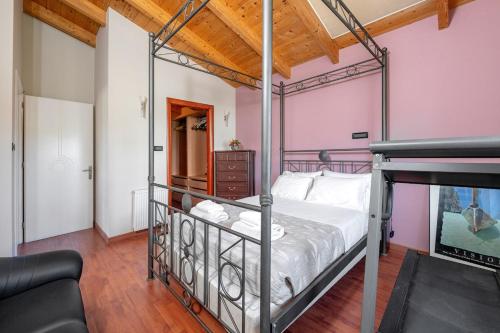 a bedroom with a metal bed in a room at Paula Cozy Villa in Corfu in Áfra