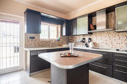 a kitchen with blue cabinets and a counter top at Paula Cozy Villa in Corfu in Áfra