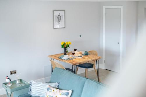 a room with a table and a blue couch at 1 Bed in Marishes oc-l32536 in Kirby Misperton