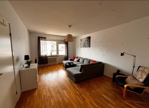 a living room with a couch and a table at Central lägenhet med balkong i Ockelbo in Ockelbo