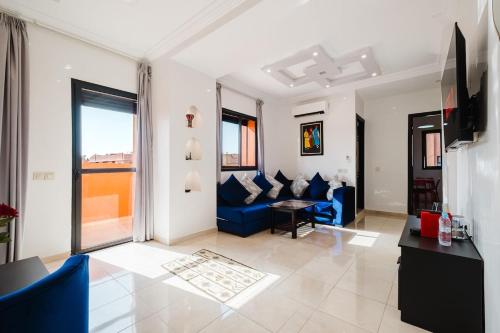 a living room with blue couches and a television at Cosy 2BR Apartment in marrakech in Marrakech