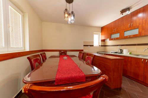 a kitchen with a wooden table and chairs and a kitchen with a counter at Apartments Golden View in Kotor