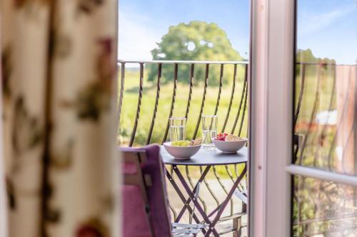 a table with two bowls of food and glasses on a balcony at 2 Bed in Carreghofa oc-t32530 in Llanymynech