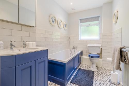 a bathroom with a tub and a toilet and a sink at 3 Bed in Llanfyllin oc-i32566 in Llanfyllin