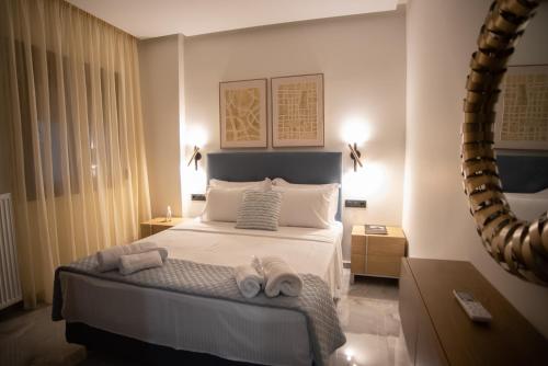 a bedroom with a bed with towels on it at Kastrino Luxury Apartment in Ioannina
