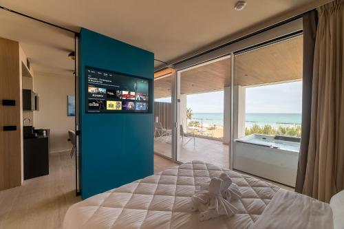 a bedroom with a large bed and a large window at Hotel Relax Family & Spa in San Benedetto del Tronto