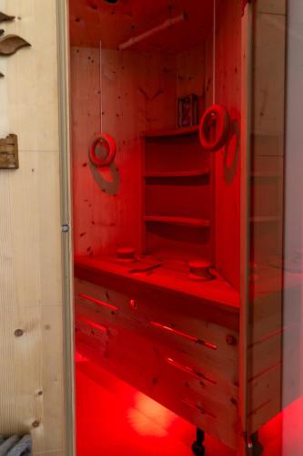 a red closet with red lights in it at Fai le Coccole in Fai della Paganella