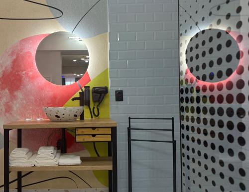 a bathroom with a sink and a mirror at Eclectic 6 in Satu Mare