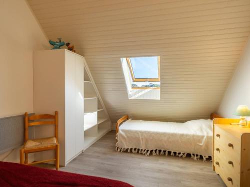 une petite chambre avec un lit et une fenêtre dans l'établissement Carnac : Duplex 2 pièces, 200m plage, terrasse sud, parking, animal accepté - FR-1-477-116, à Carnac