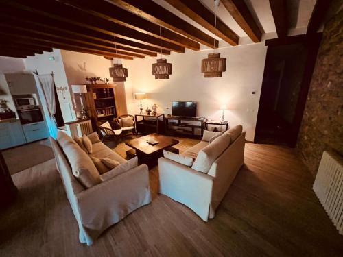 a living room with two couches and a tv at Casa Menta in Cañícosa